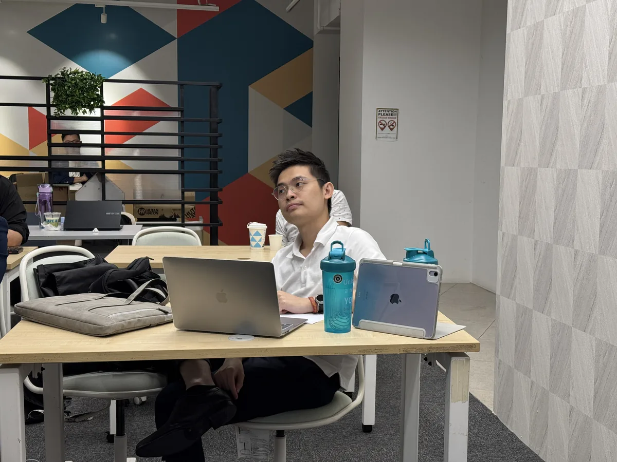 A participant working on his laptop during the AI video creation session