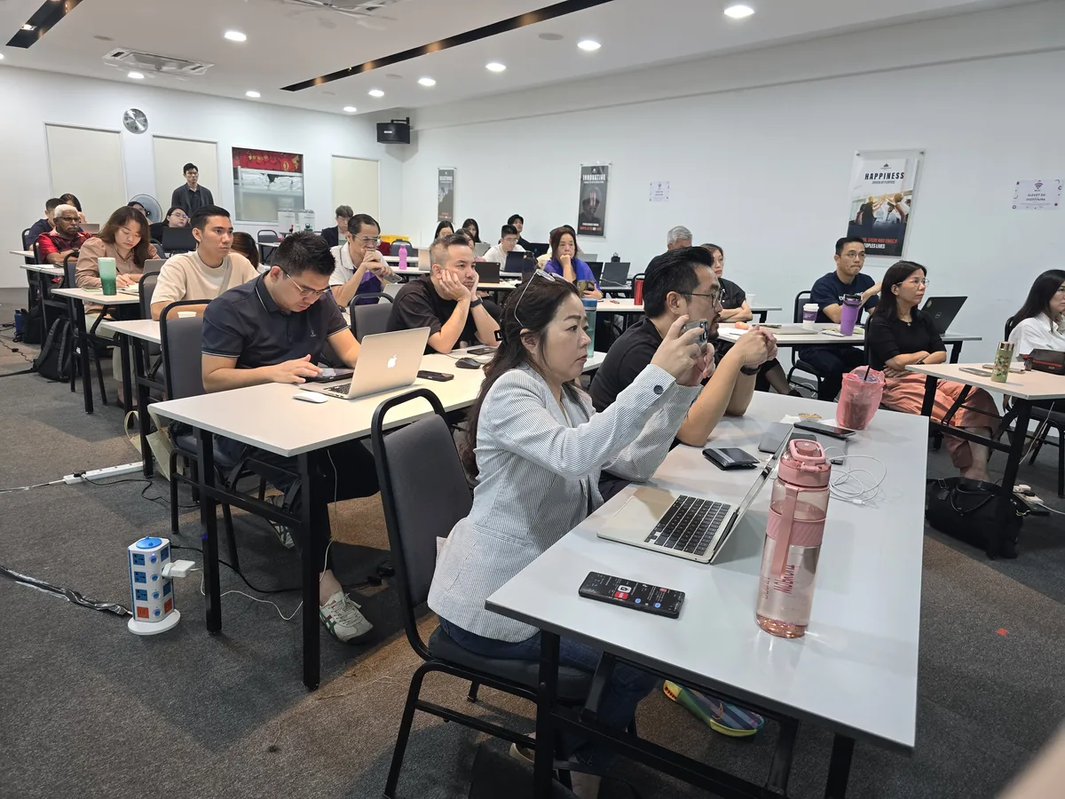 Participants practising with phones and laptops during the session
