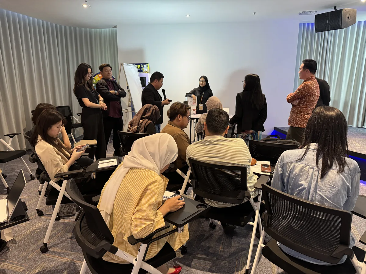 A participant practising live selling on the mic with coaching
