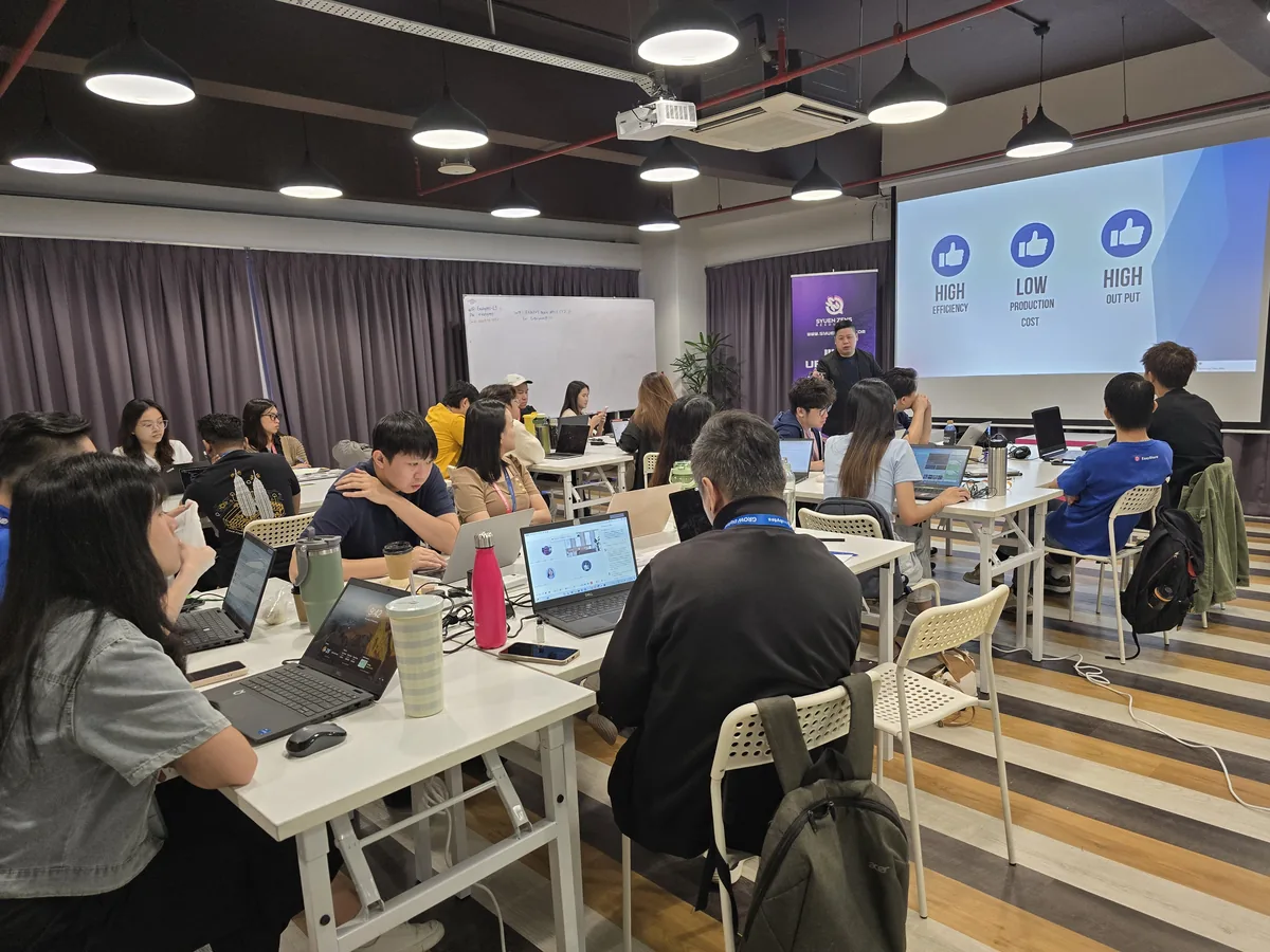 Exabytes team members at their laptops during the AI Video Creation Workshop