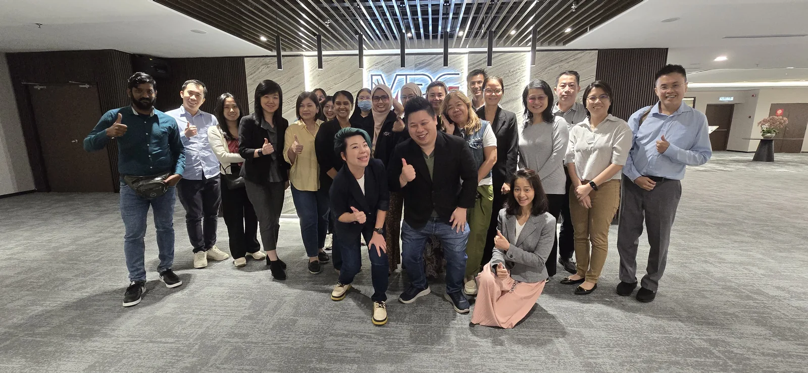 Group photo of participants with AIGC Malaysia in front of the MPC sign after the AI training session