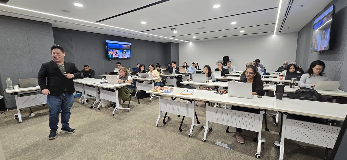 Max Ng walking the classroom during the hands-on AI training
