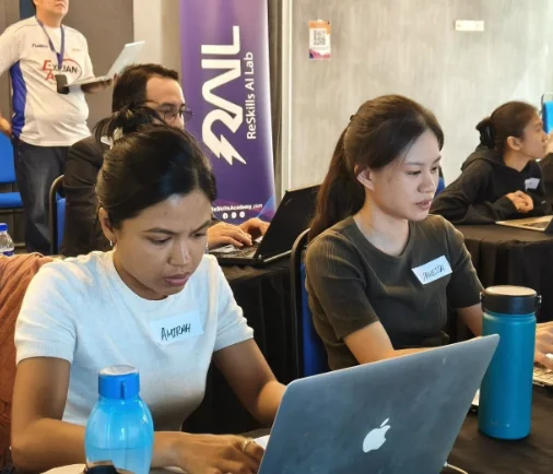 Participants working hands-on with AI video tools on their laptops